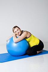 Image showing Pregnant woman relaxing against fitness ball