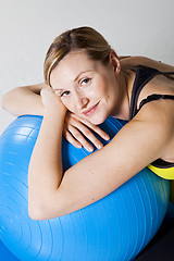 Image showing Pregnant woman relaxing against fitness ball