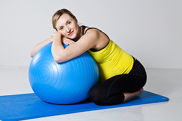 Image showing Pregnant woman relaxing against fitness ball