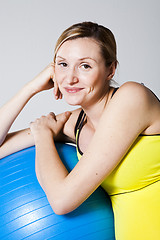 Image showing Pregnant woman relaxing against fitness ball