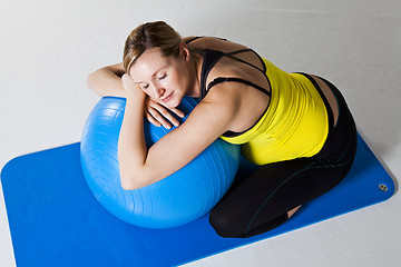 Image showing Pregnant woman relaxing against fitness ball
