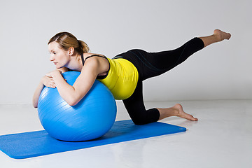 Image showing Pregnant woman exercising with fitness ball