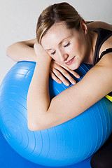 Image showing Pregnant woman relaxing against fitness ball