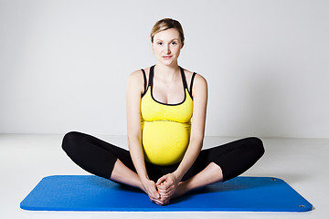Image showing Pregnant woman stretching