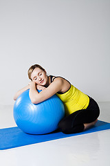 Image showing Pregnant woman relaxing against fitness ball