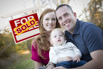 Image showing Happy Young Family in Front of Sold Real Estate Sign