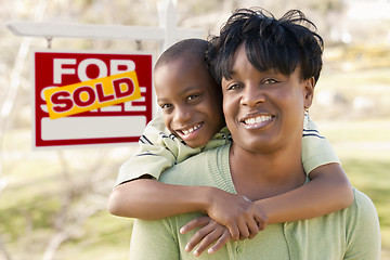 Image showing Mother and Child In Front of Sold Real Estate Sign