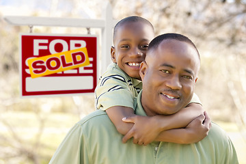Image showing Father and Son In Front of Sold Real Estate Sign
