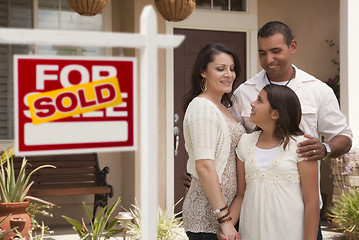 Image showing Hispanic Family in Front of Home with Sold Real Estate Sign