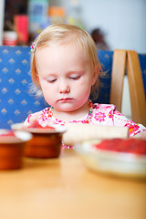 Image showing Little girl helping at kitchen