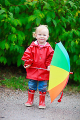 Image showing Toddler girl with umbrella outdoors on rainy autumn day