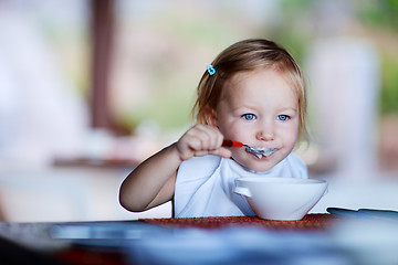 Image showing Toddler girl having breakfast