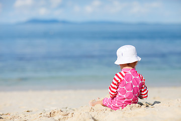 Image showing Toddler girl sitting on white sand beach