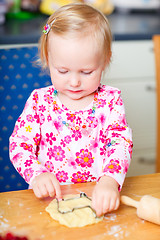 Image showing Little girl baking cookies