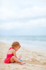 Image showing Toddler girl playing with toys at beach