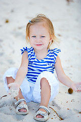 Image showing Little girl playing with sand