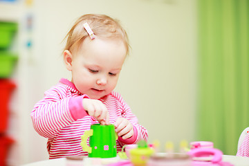 Image showing Little girl playing with toys