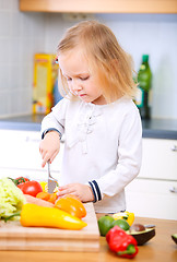 Image showing Adorable little girl helping at kitchen