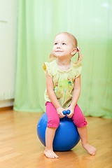 Image showing Toddler girl jumping on ball