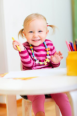 Image showing Toddler girl drawing with pencils