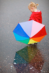 Image showing Toddler girl with colorful umbrella on rainy day