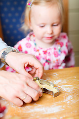 Image showing Closeup of family baking cookies