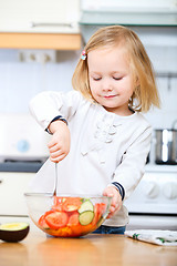 Image showing Adorable little girl helping at kitchen