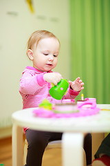 Image showing Little girl playing with toys