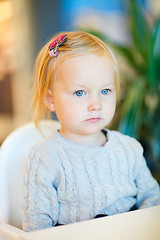 Image showing Toddler girl sitting at table