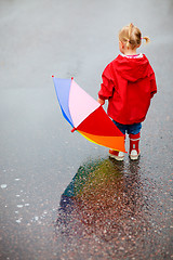 Image showing Toddler girl outdoors at rainy day