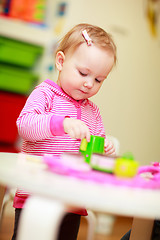 Image showing Little girl playing with toys