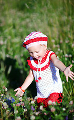 Image showing Cheerful toddler girl in meadow