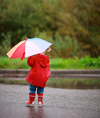 Image showing Toddler girl outdoors at rainy day