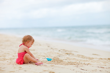 Image showing Toddler girl playing with sand