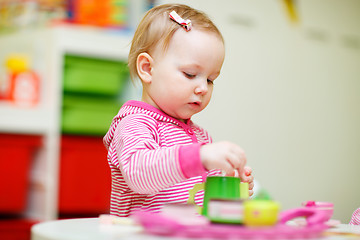 Image showing Toddler girl playing with toys