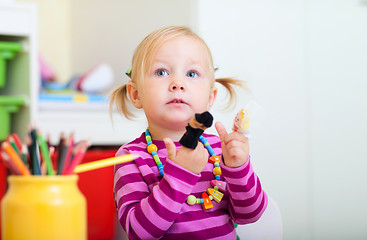 Image showing Toddler girl playing with finger toys