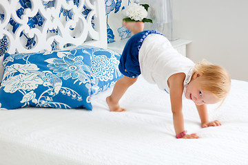 Image showing Adorable playful toddler girl in bedroom