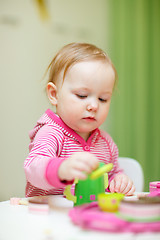 Image showing Toddler girl playing with toys