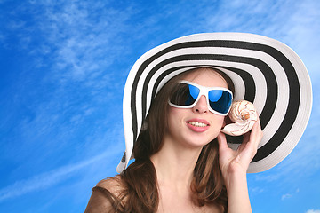 Image showing girl listens seashell