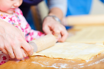 Image showing Closeup of family baking pie