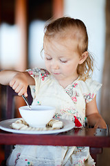 Image showing Girl eating breakfast