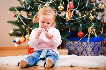 Image showing Toddler girl with Christmas candy