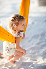 Image showing Cute little girl swinging in hammock