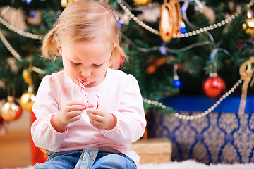 Image showing Toddler girl with Christmas candy