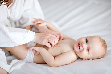 Image showing Family playing in bed