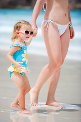 Image showing Mother and daughter walking at beach