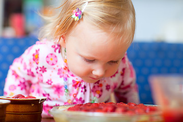 Image showing Adorable toddler with strawberry pie