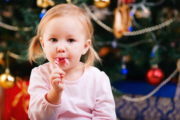 Image showing Toddler girl with Christmas candy