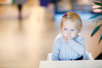 Image showing Toddler girl sitting at table