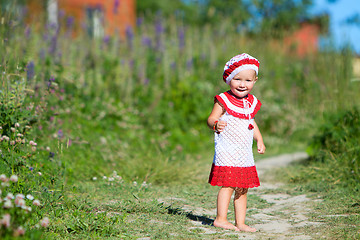 Image showing Playful toddler girl in meadow